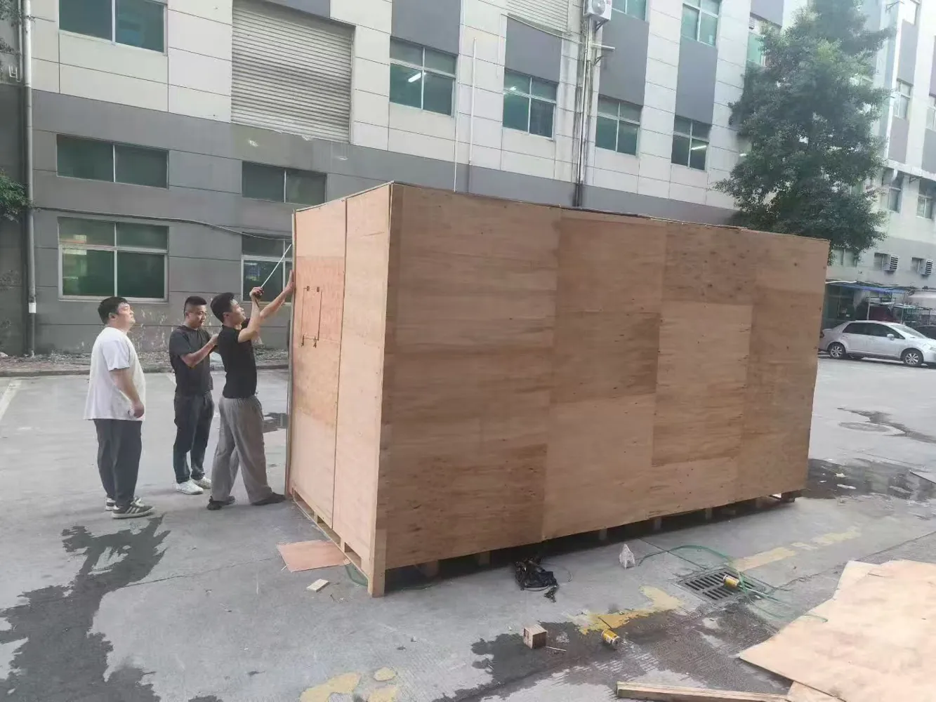 Xinyang team preparing an oversized export crate